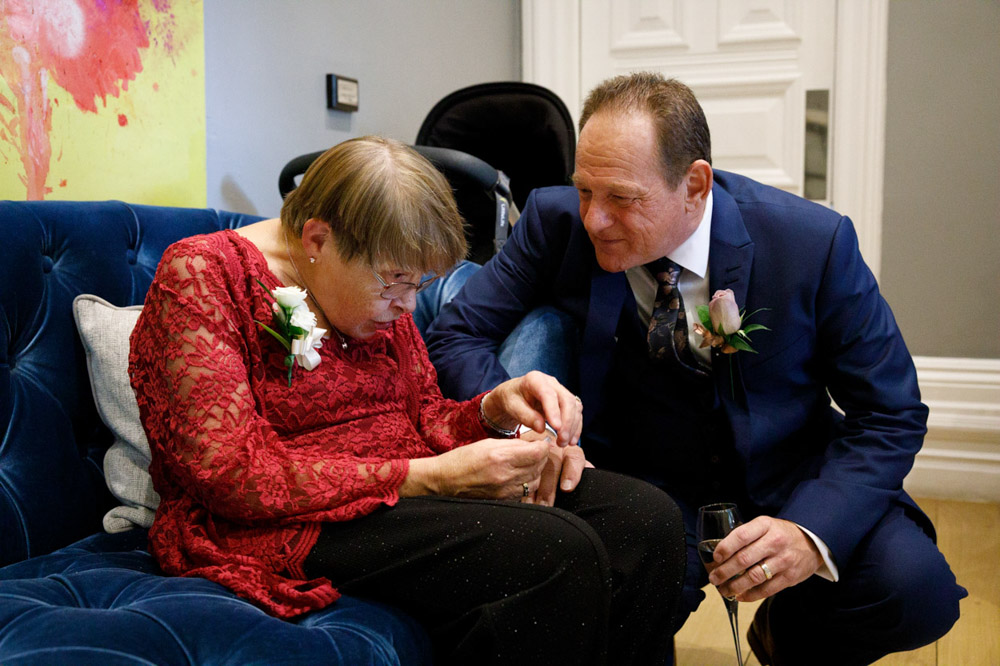 Gary chatting with an elderly relative in the light after the ceremony