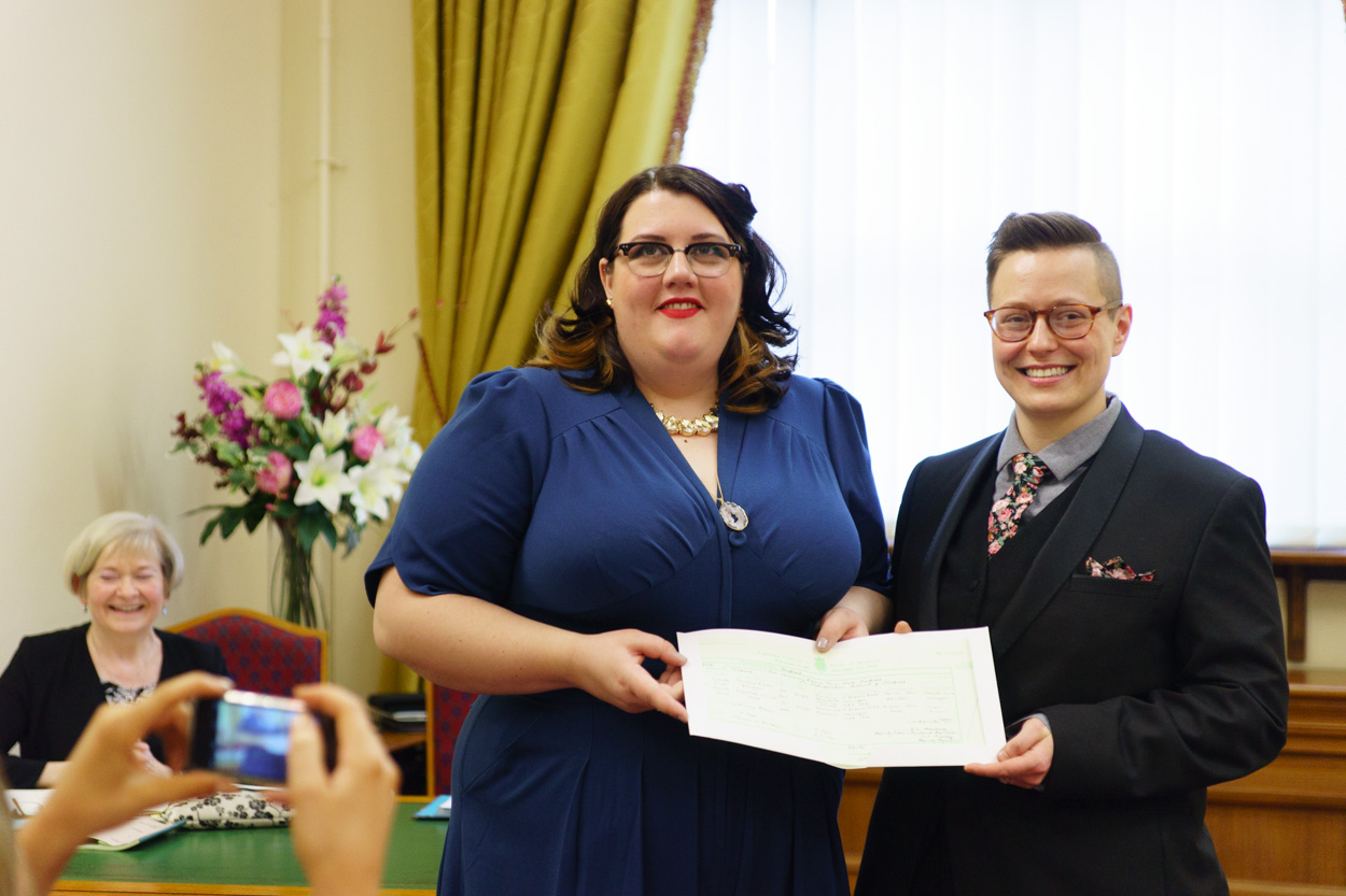 Lizzie and Tamara holding their marriage certificate