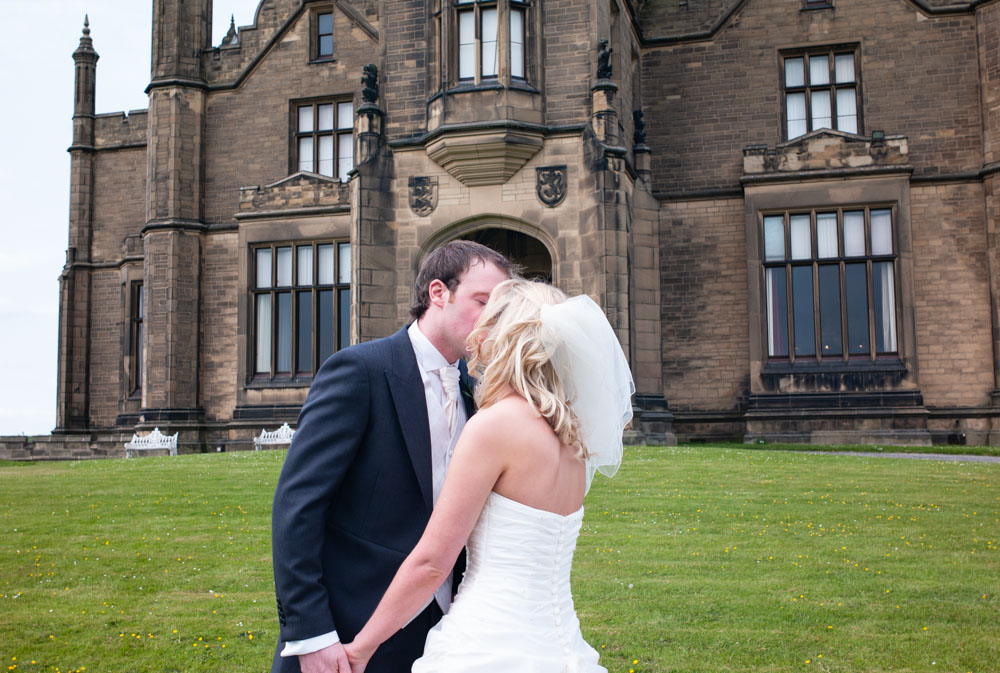 Close-up of a kiss between the newlyweds, eyes closed