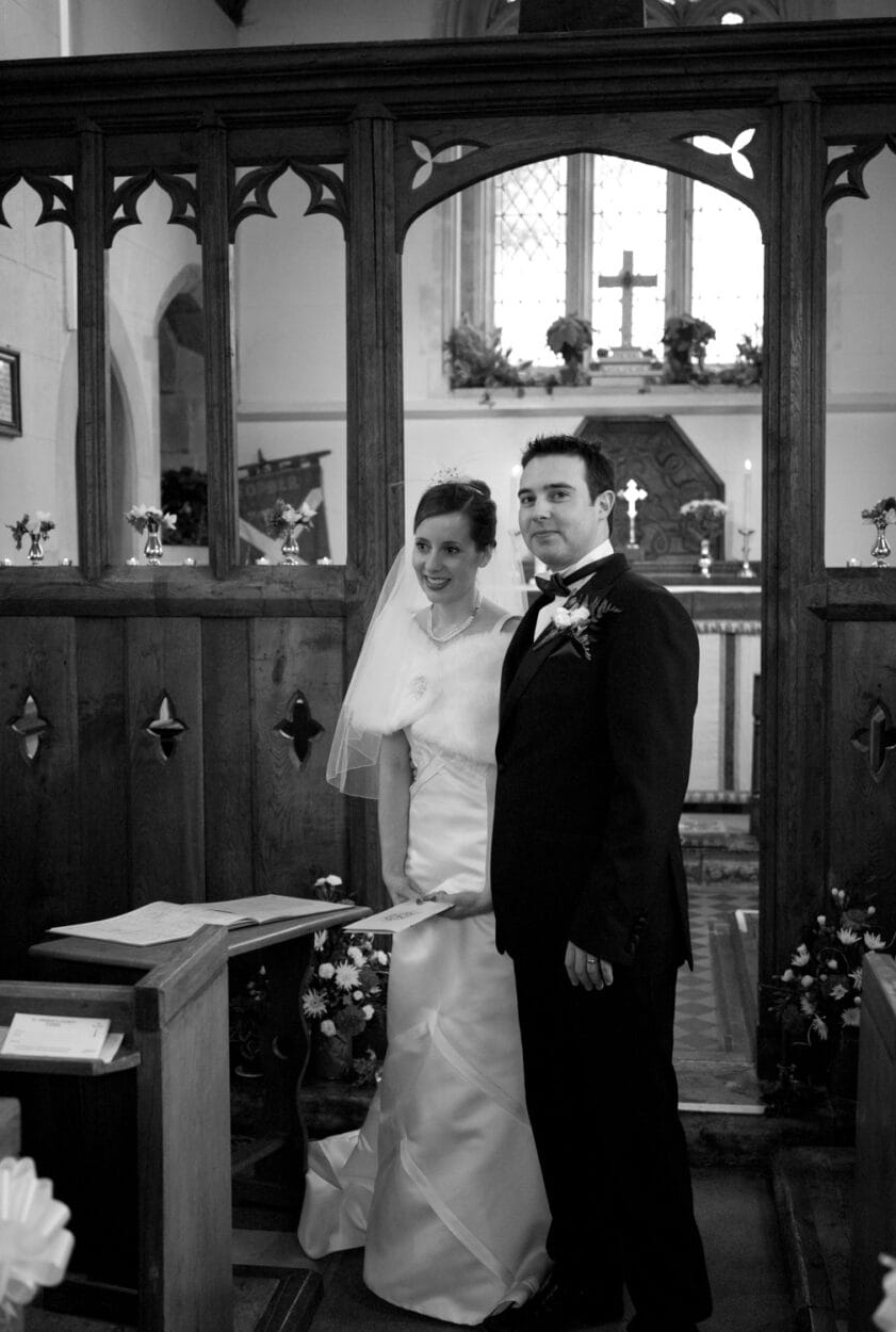 Groom looks toward the camera in black and white.