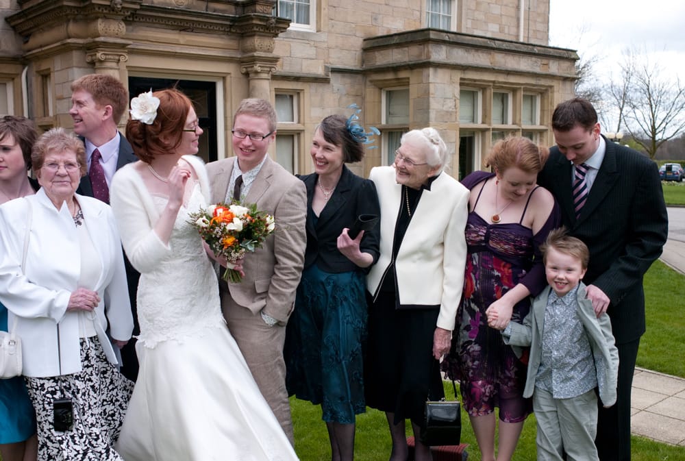 Close-up on right side of family group during portraits at Weetwood Hall.