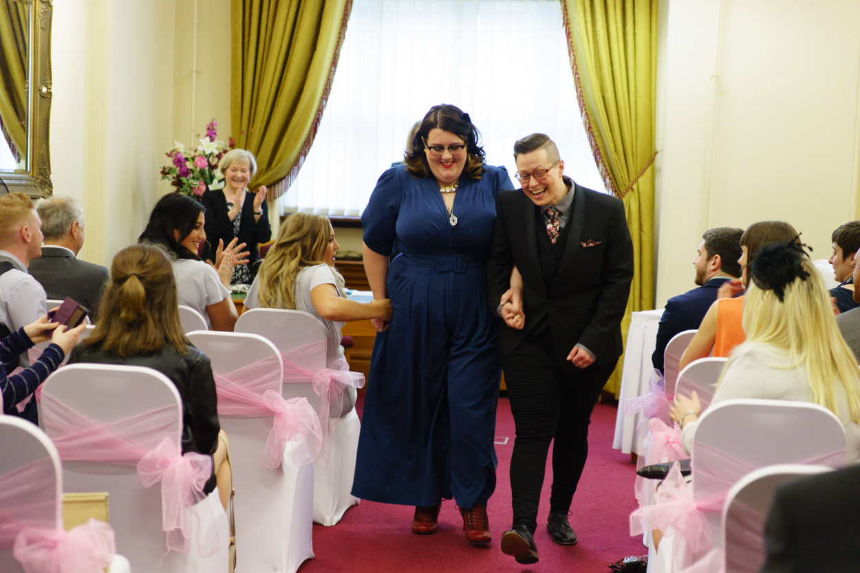 Lizzie and Tamara walking down the aisle together dancing