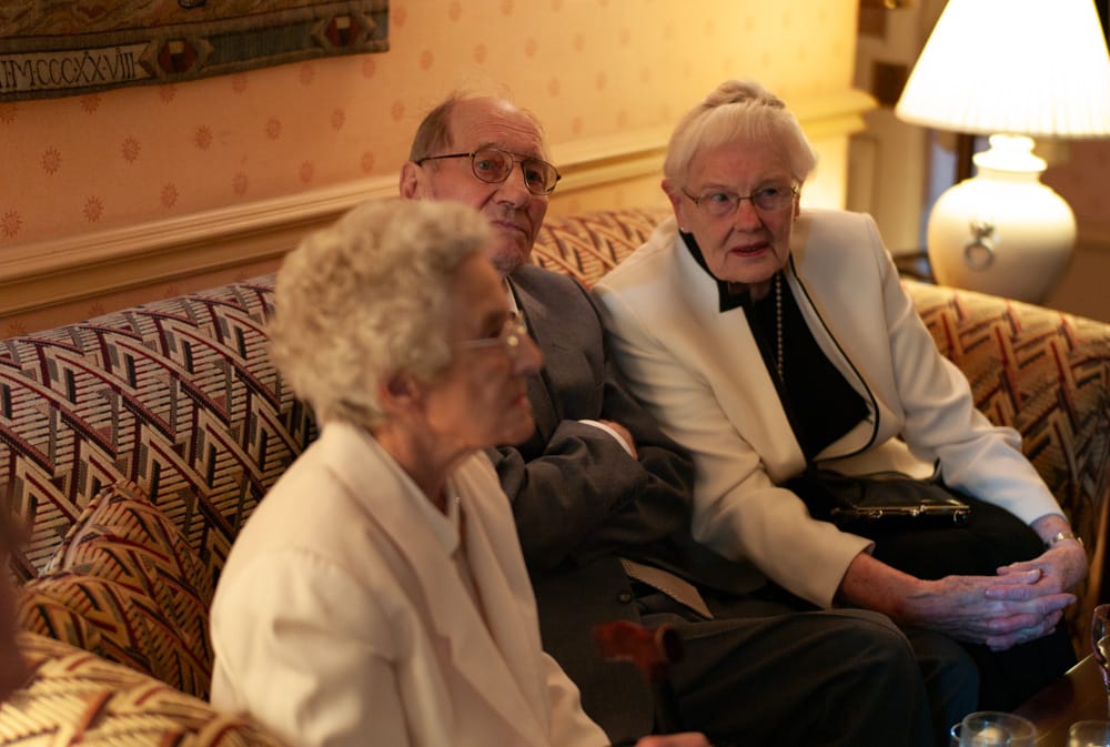 Elderly wedding guests relaxing comfortably on a sofa at Weetwood Hall Leeds.