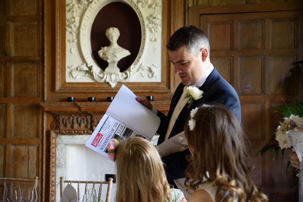Bride and her mother laugh together while looking at the gifts.