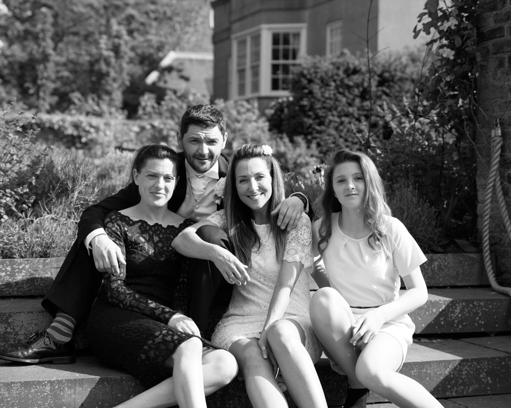 Black and white photo of family group seated outdoors at Grays Court.