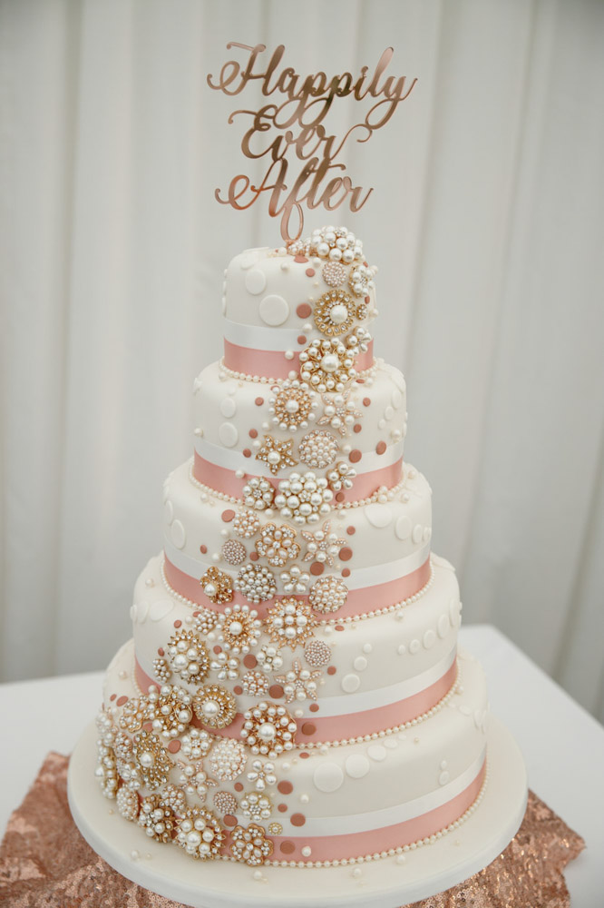 Happily Ever After wedding cake topped with gold decor
