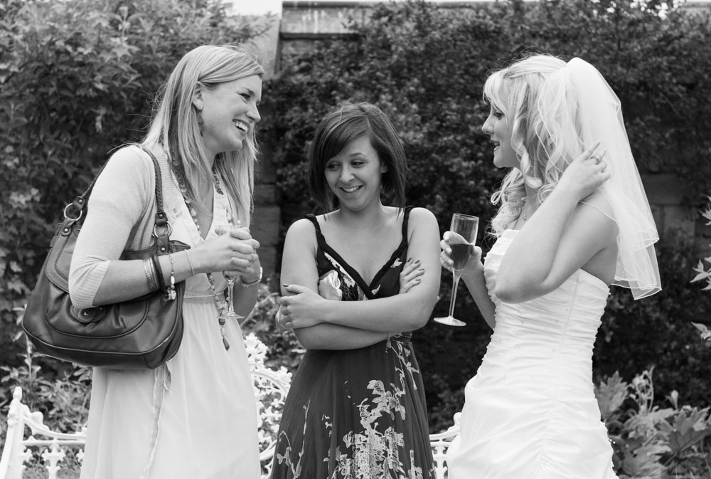Black and white image of Vicky laughing with her friends