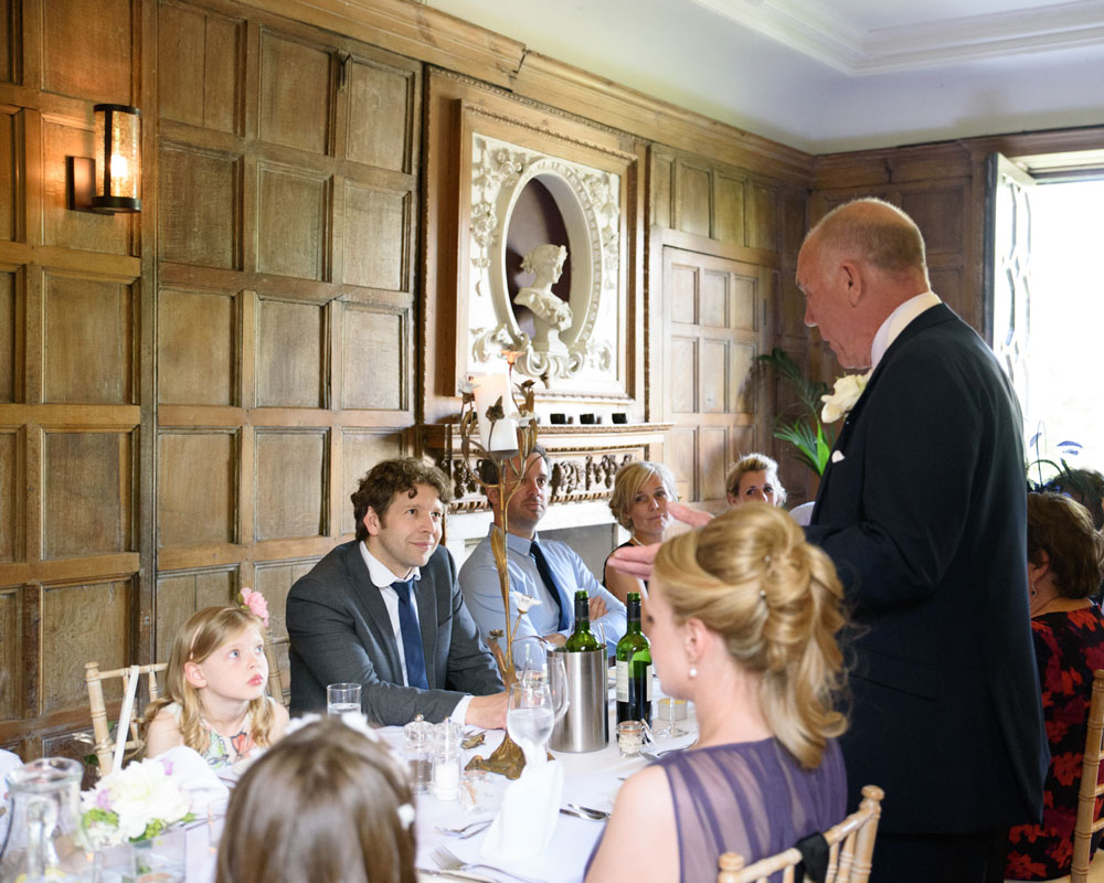 Father of the bride gives his speech at the cosy, family-style long table.