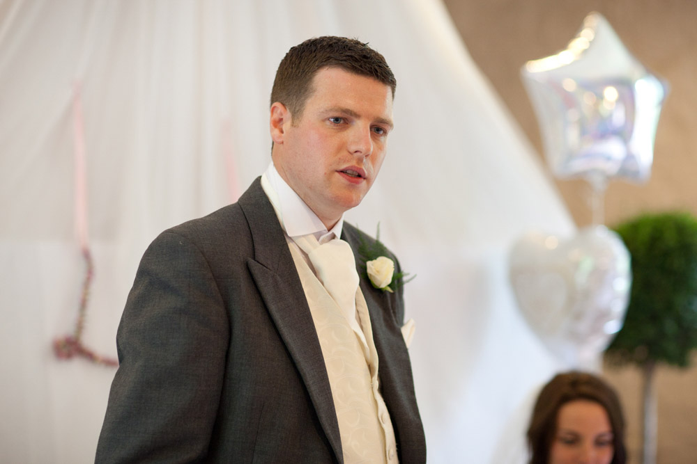 Groom Tim begins his wedding speech at the top table