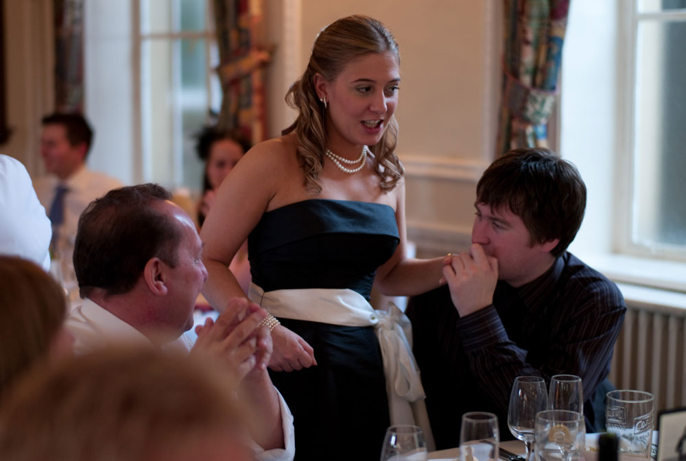 Dani’s sister’s boyfriend kisses her hand at the top table