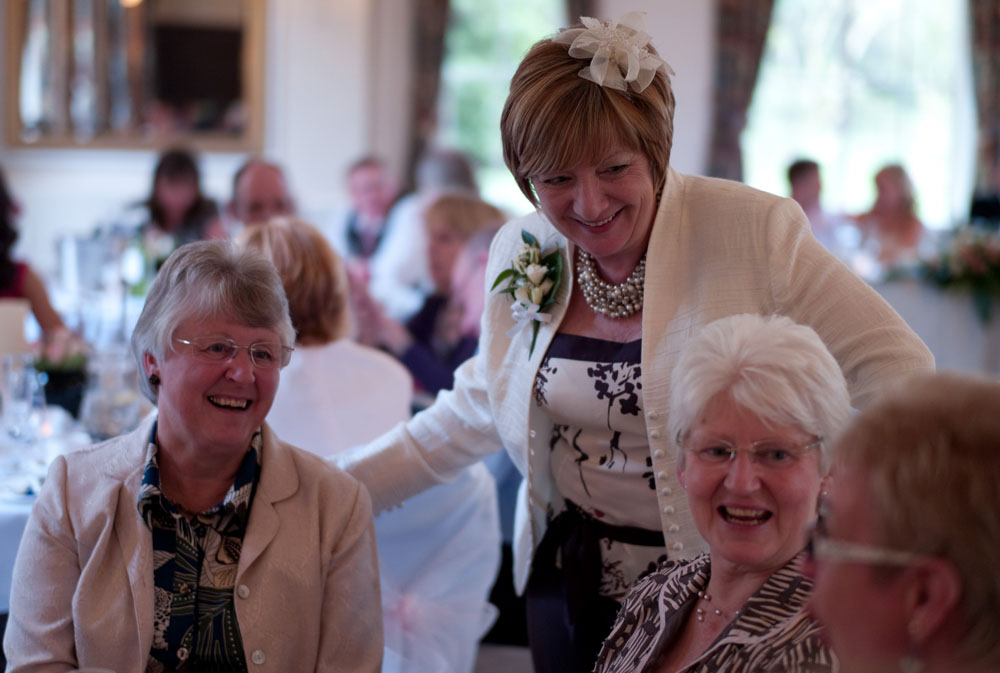 Dani’s mum visits a table of elderly guests during the wedding breakfast