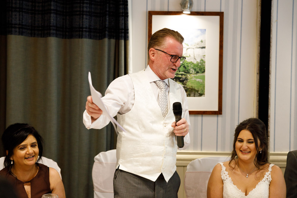 Kyra and her mum share a smile as they listen to the father’s speech at the wedding reception.