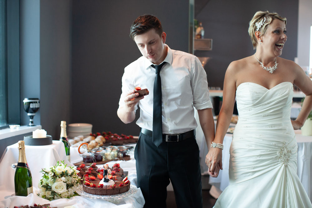 Tim eats more cake while Sam laughs at his enthusiasm.