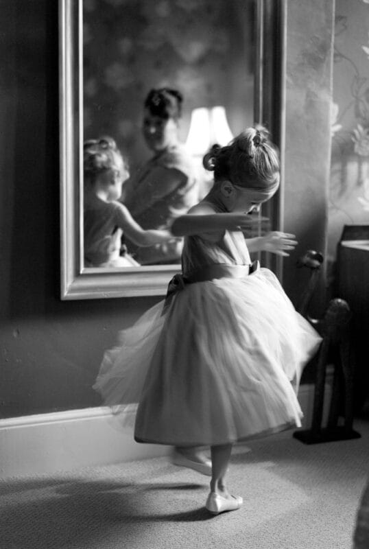 Bridesmaid twirling by the mirror in black and white during wedding morning prep