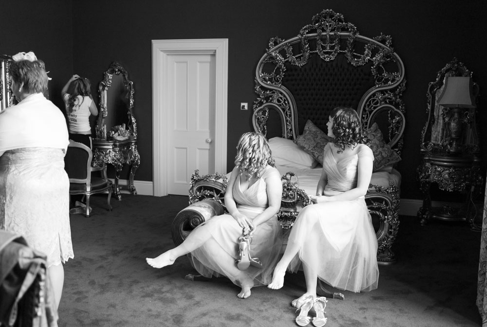 Bridesmaids on the chaise in the bridal suite at Allerton Castle in black and white