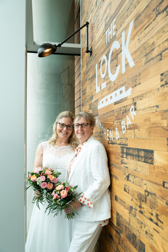 Clare & Tracey, a natural couple portrait outside the Lock Bar by the DoubleTree Hilton, Leeds - wedding photography by Tim Christian Jones