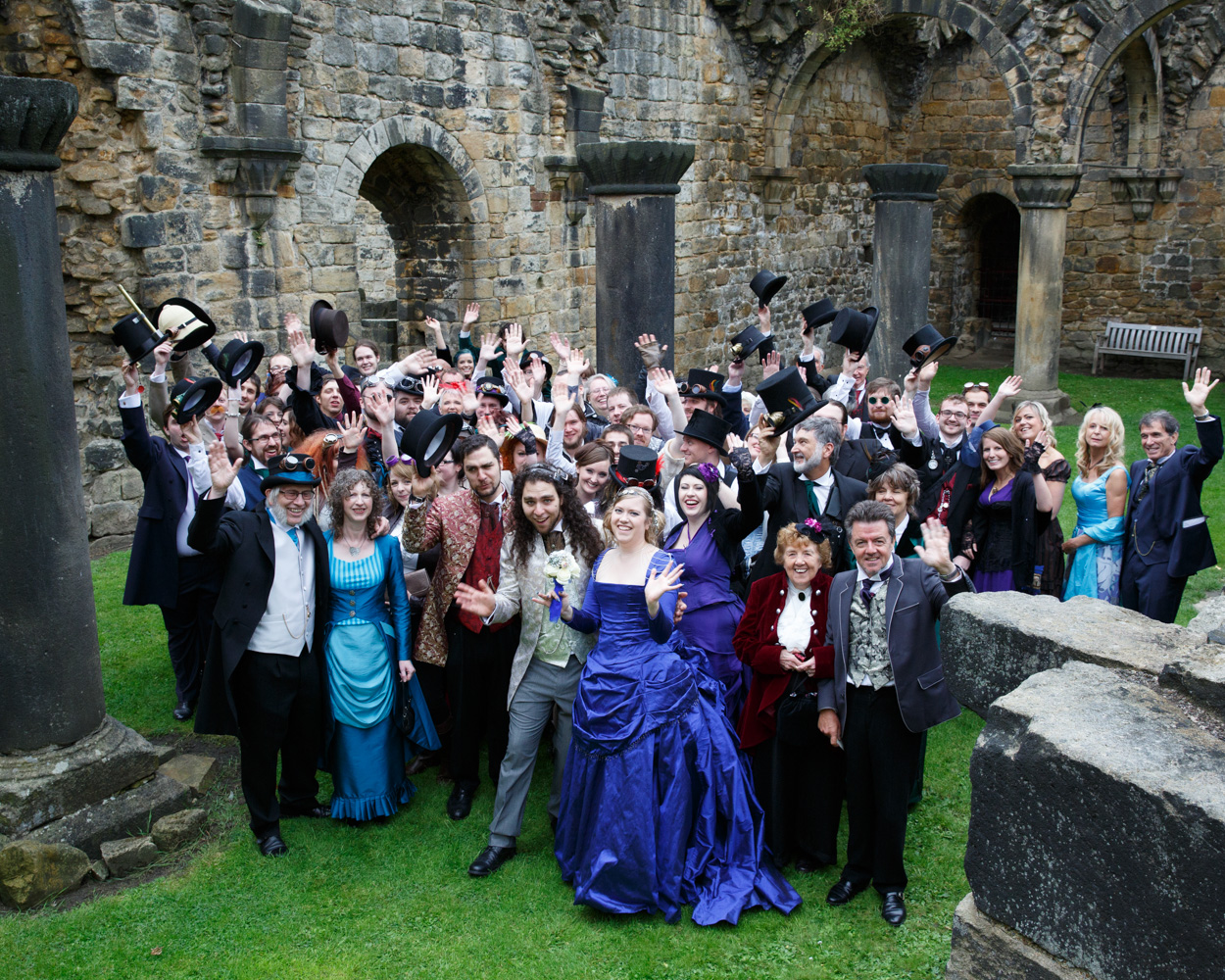 A joyful group photo inside the Abbey ruins with friends and family