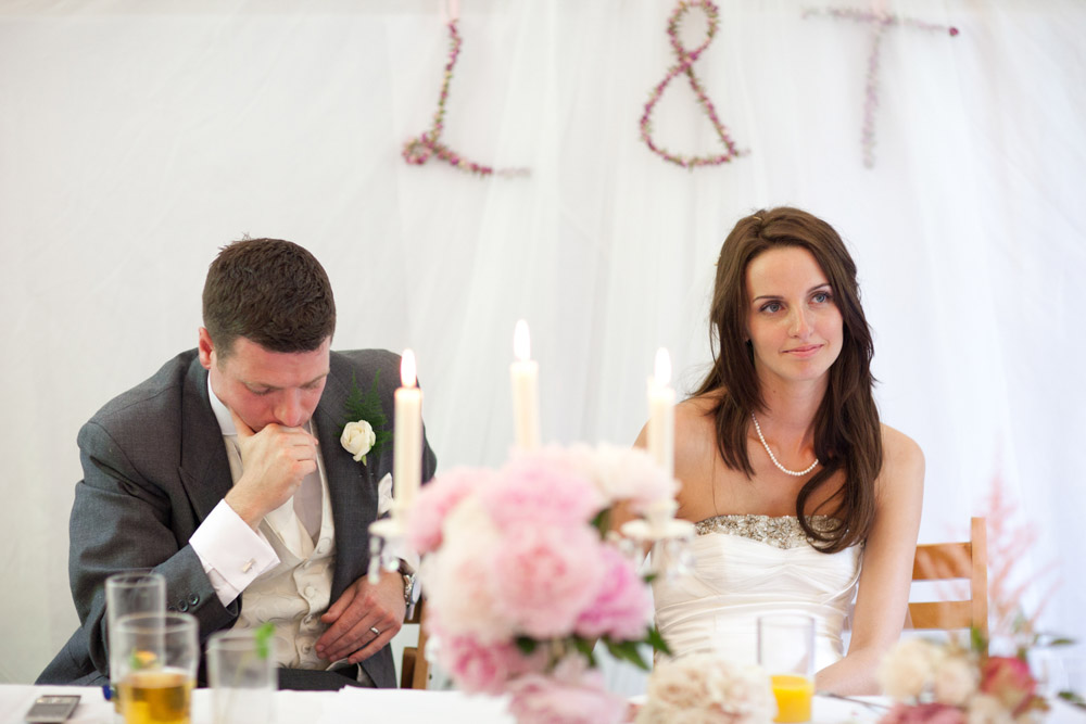 Groom holding back emotion while Lowri remains calm beside him