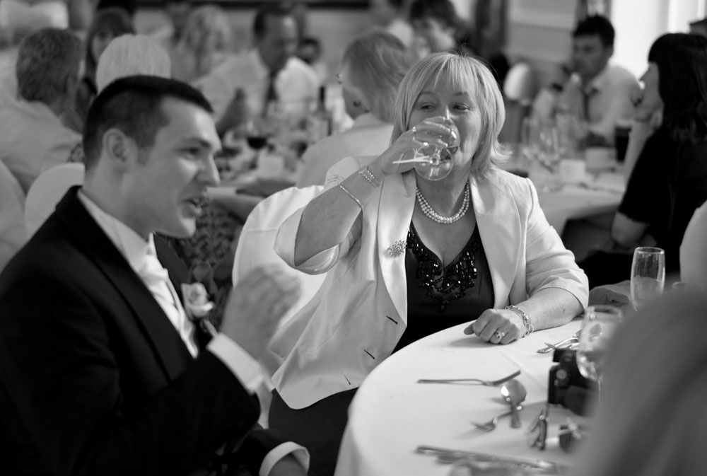 Scott chats and smiles with friends at their table during the reception
