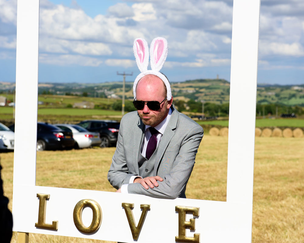 Wedding guest outside wearing bunny ears during the celebration.