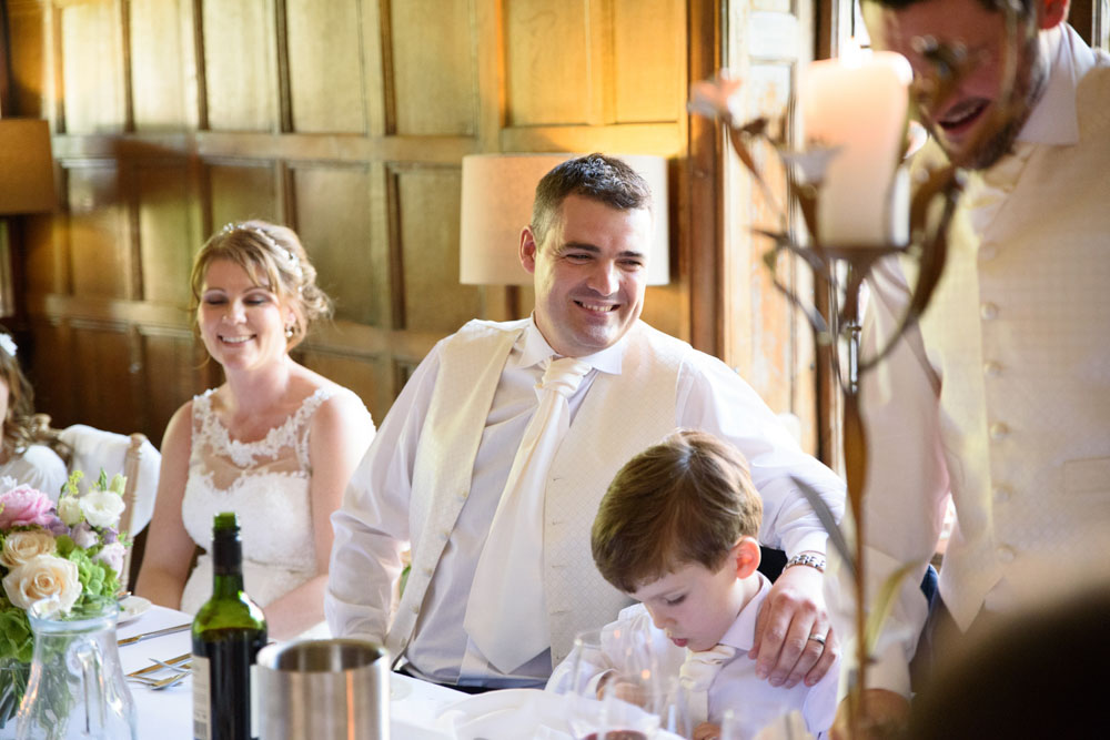 Best man begins his speech to warm smiles from the top table.