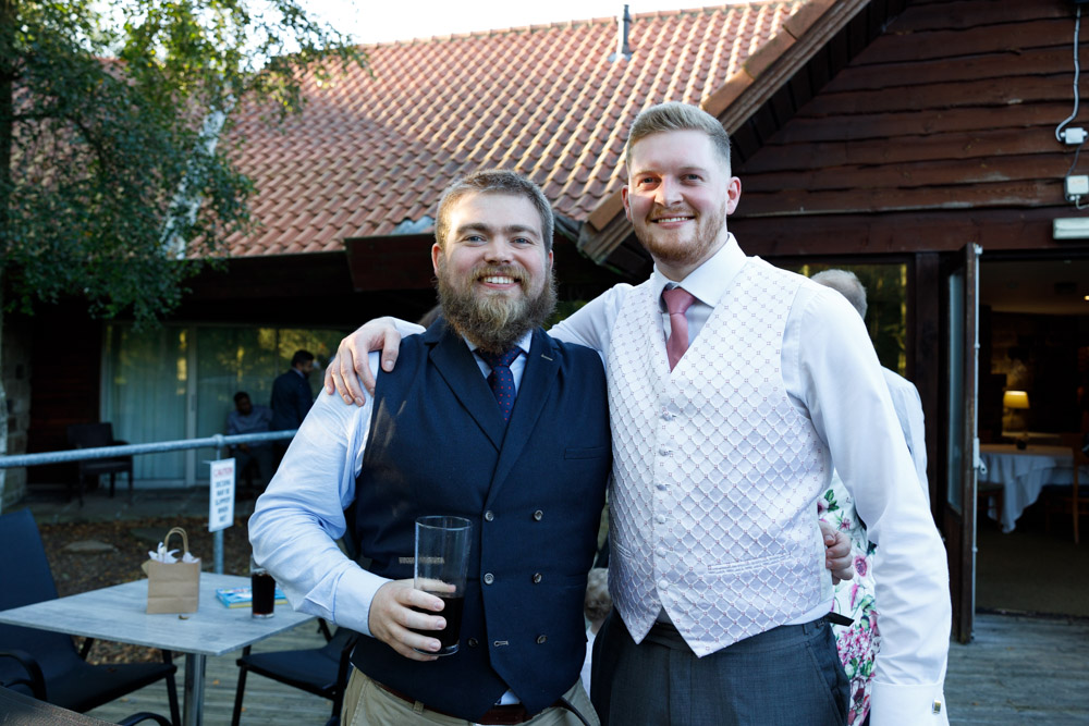 Matt and a guest smile warmly as they pose for a relaxed photo together in the sunshine.
