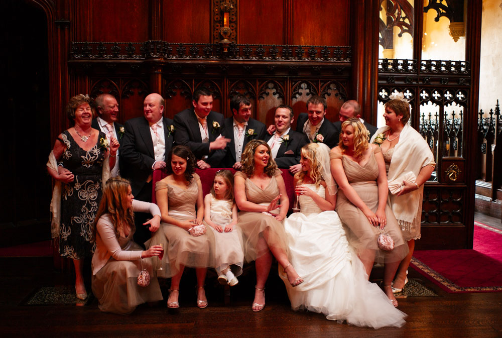 Wider group shot with mother of the bride joining in the rich indoor setting