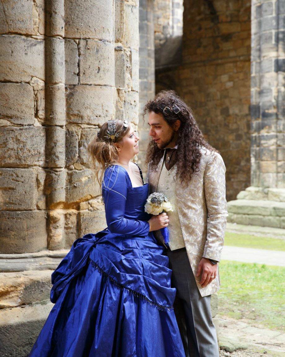 080 couple portrait by the abbey columns a contrast of blues against the ancient stone at kirkstall abbey wedding linsey and chris