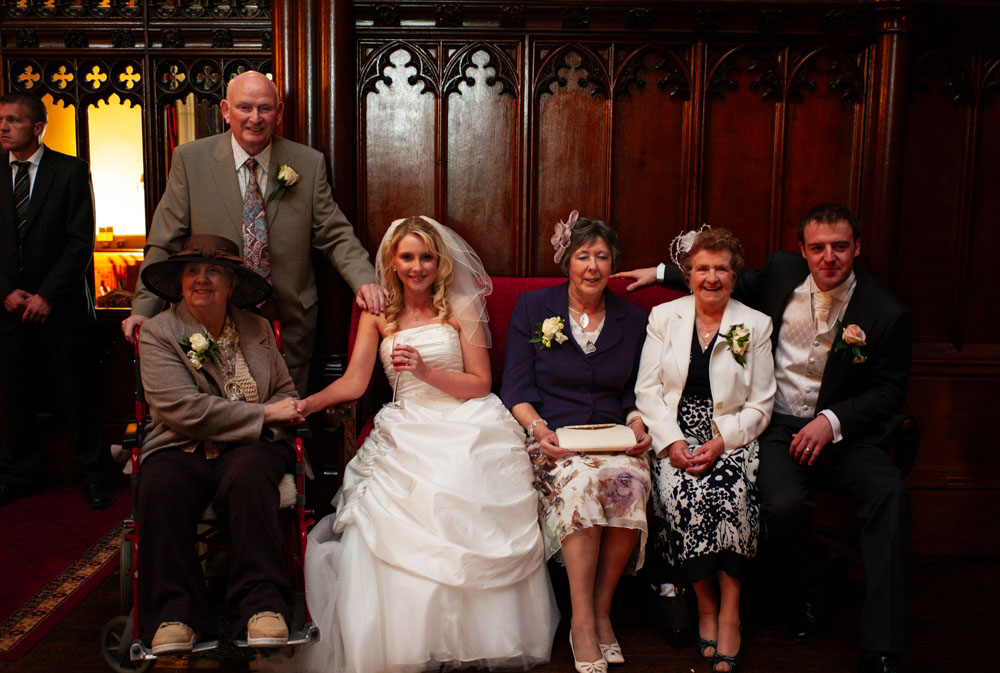Multi-generational family photo with grandparents and extended family