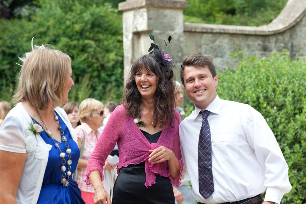 Bride’s brother, mum and a close friend standing together outside