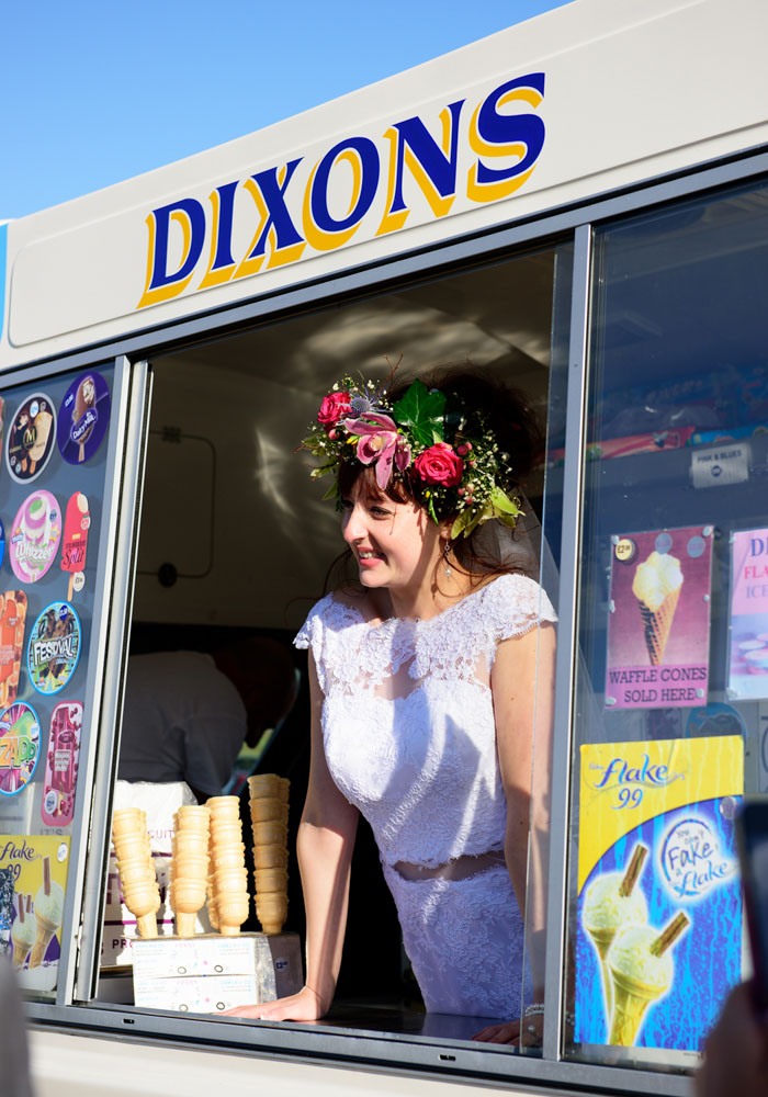 Chloe leans at the ice cream van window with a joyful smile.
