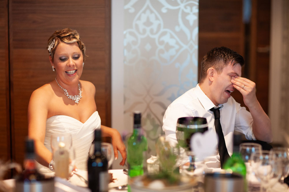 Sam and Tim react to the best man’s speech with laughter and just a hint of embarrassment.