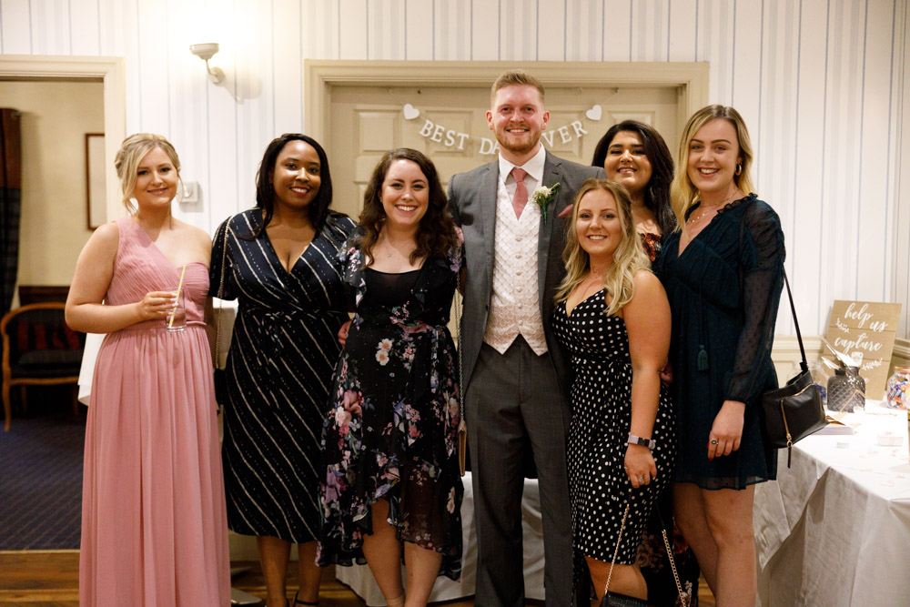 Matt joins a spontaneous group of friends for a casual and candid wedding photo.