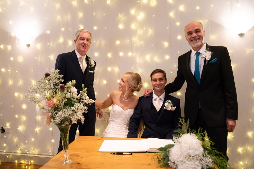 The couple pose with both their fathers at the Chilli Barn wedding.