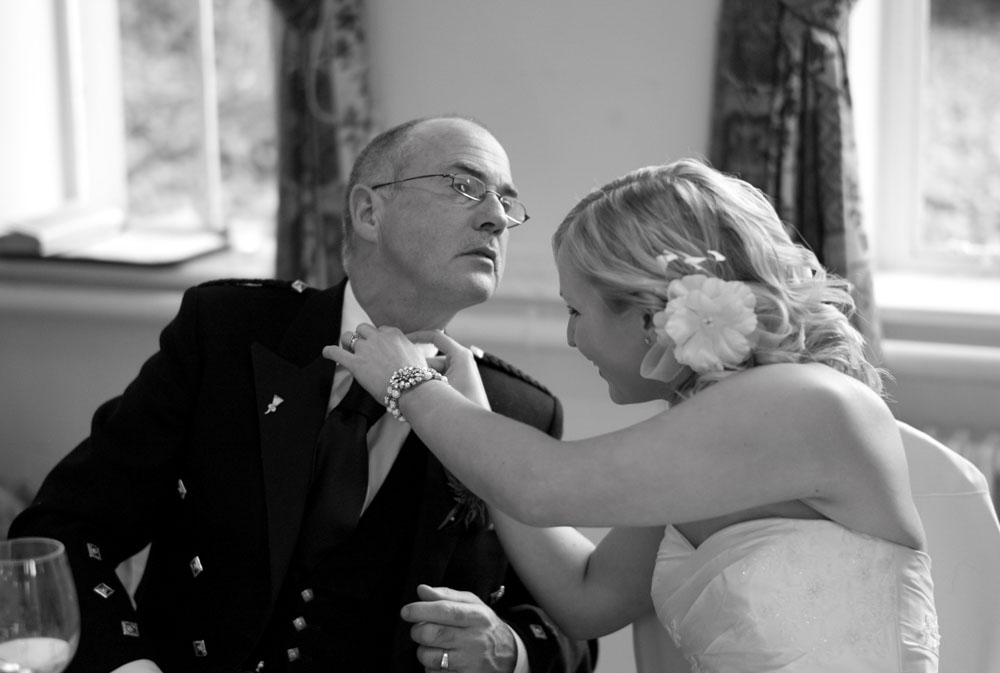 Dani helps her father adjust his cravat as the speeches are about to begin.