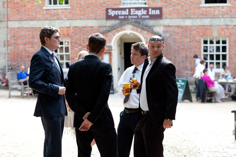 Guests chatting near The Spread Eagle Inn with hog roast cooking in the background