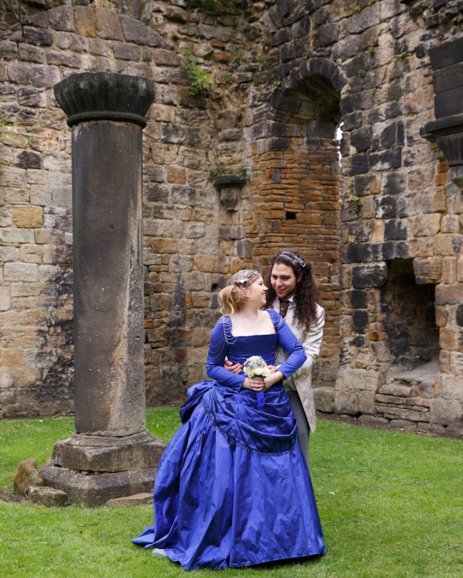087 couple pose by a lone pillar in the grounds kirkstall abbey wedding linsey and chris