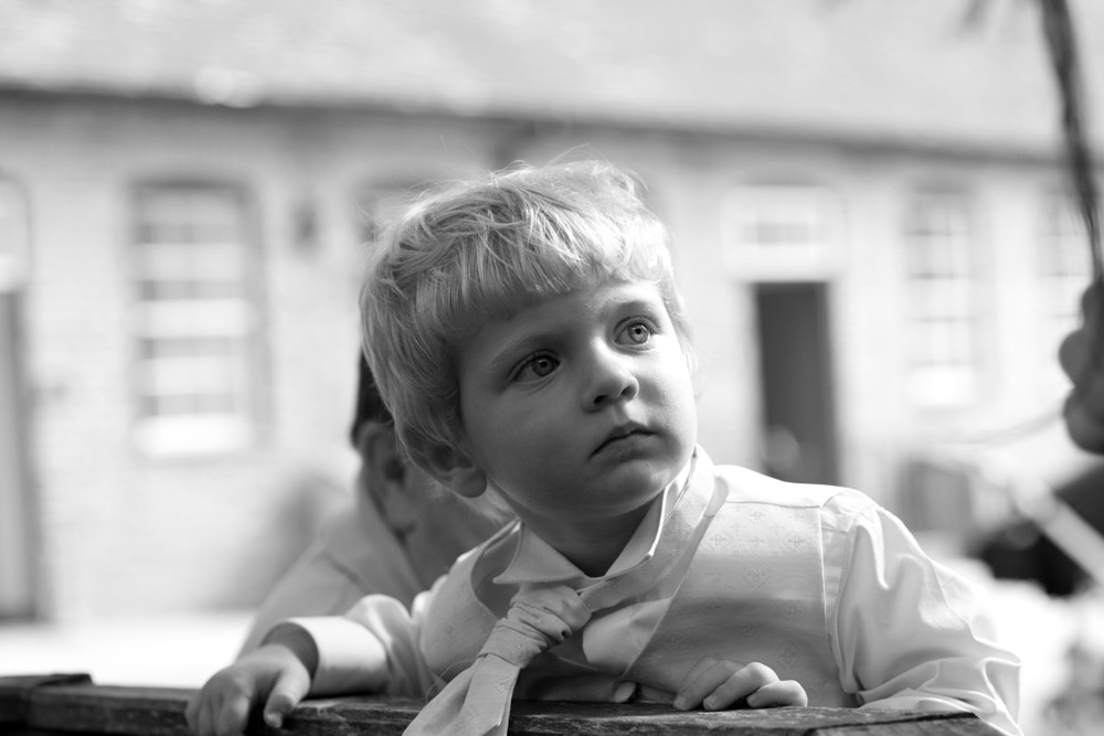 Black and white photo of the couple’s son, looking thoughtful