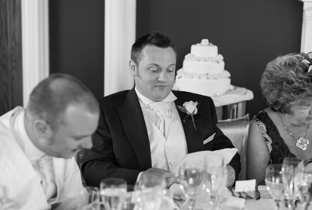 Best man checking his speech notes in black and white