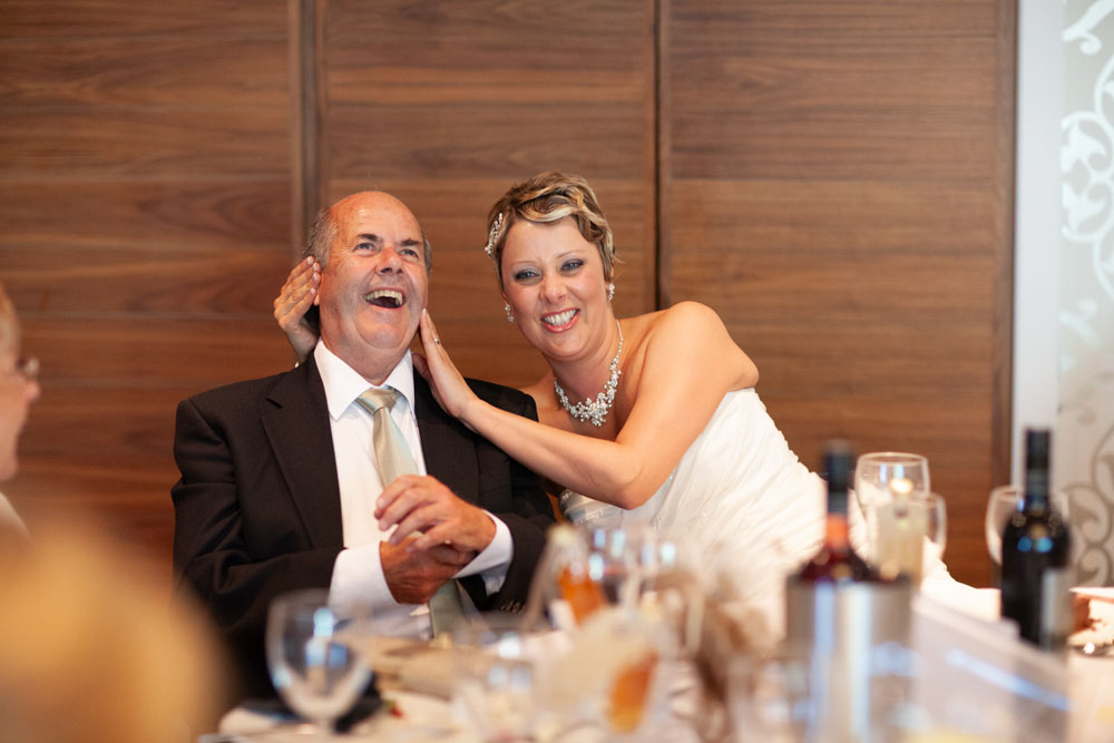 Sam playfully covers her father’s ears as the stories take a cheeky turn.
