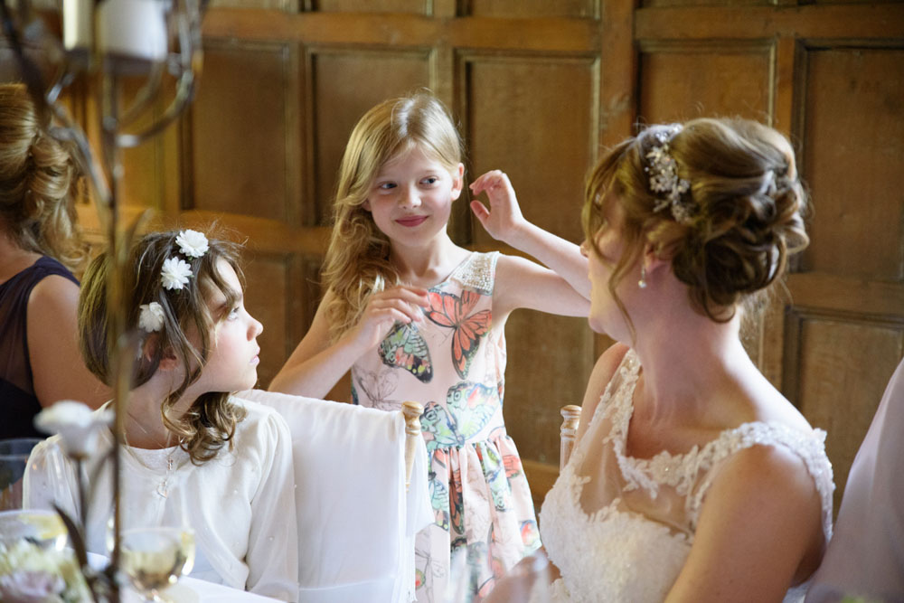 The bride’s young schoolchild comes to chat during the celebration.