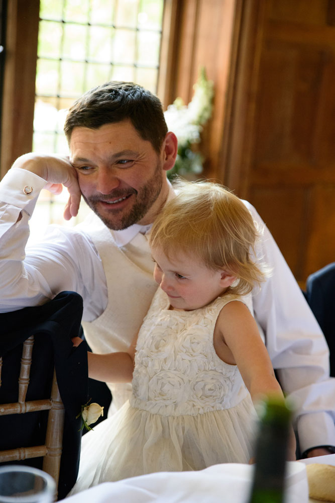 Best man shares a moment with his young daughter.
