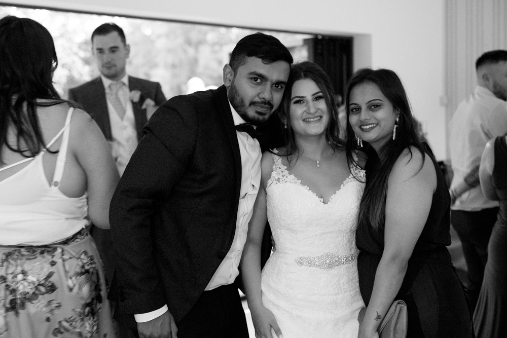Black and white portrait of Kyra smiling during the evening reception — soft focus and gentle emotion.