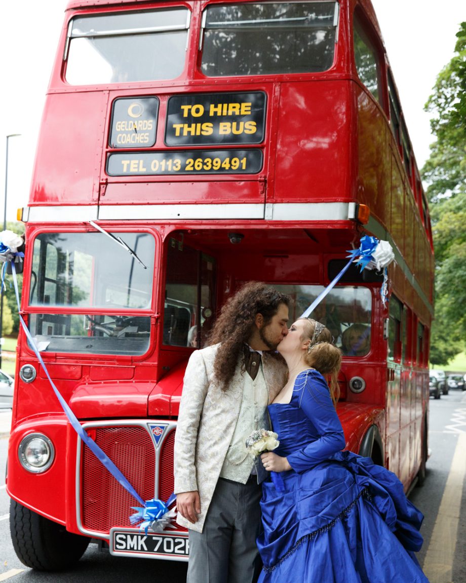 092 the wedding bus to transport all to left bank leeds the couple kiss the bus behind them kirkstall abbey wedding linsey and chris
