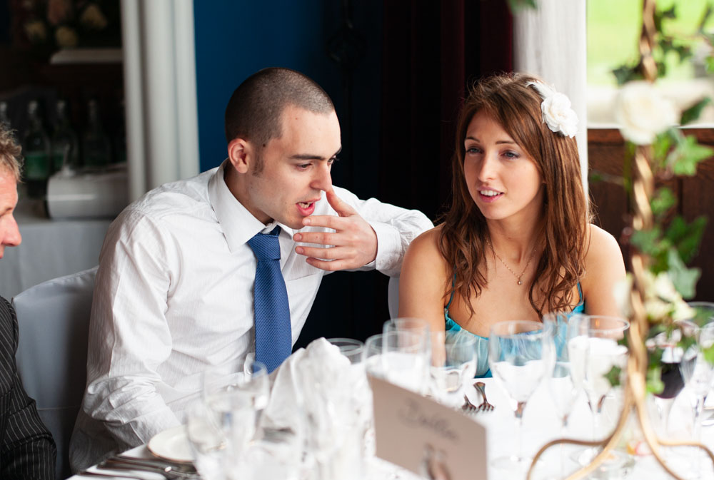 Couple chatting at the table, captured in warm natural light