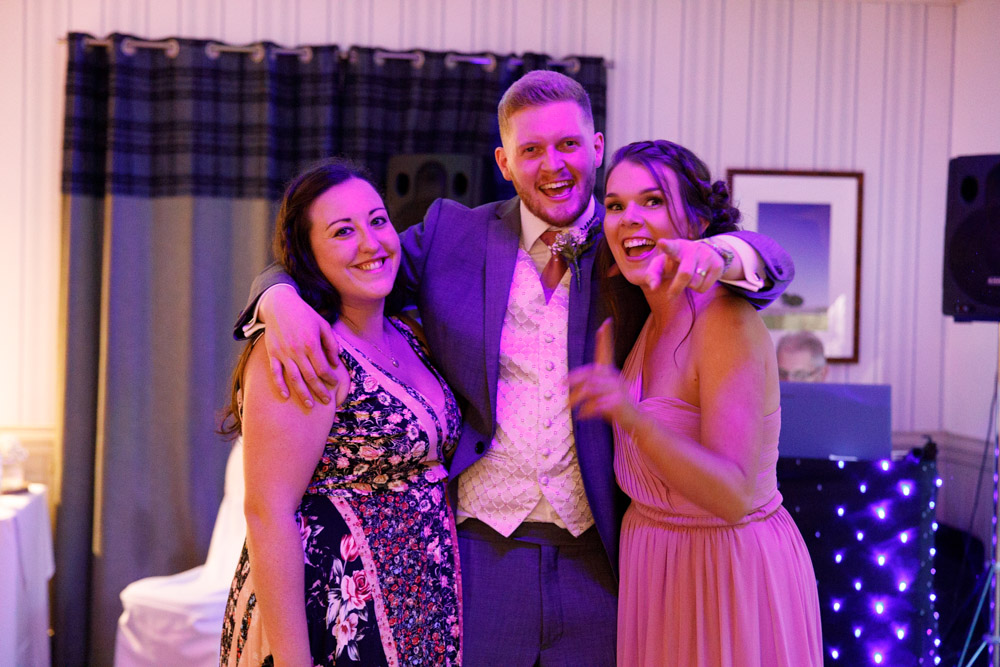 Matt with two close friends during the evening reception at Chevin, relaxed and smiling for the photo.