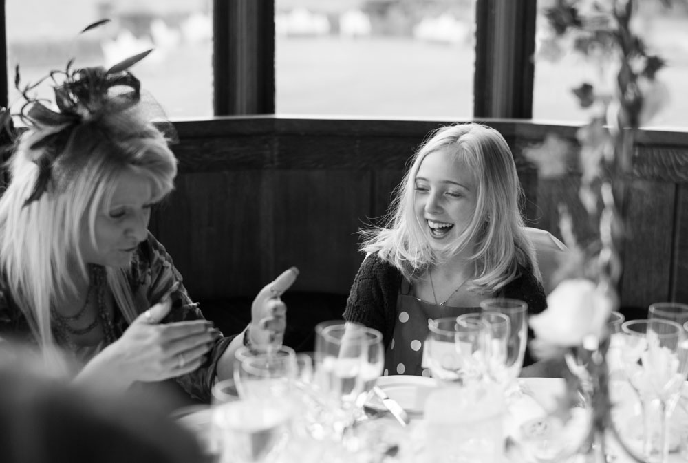 Young guest laughing after something her mum said