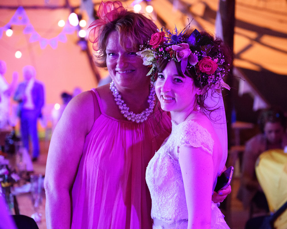 Bride Chloe and a friend pose together for a smiling photo.