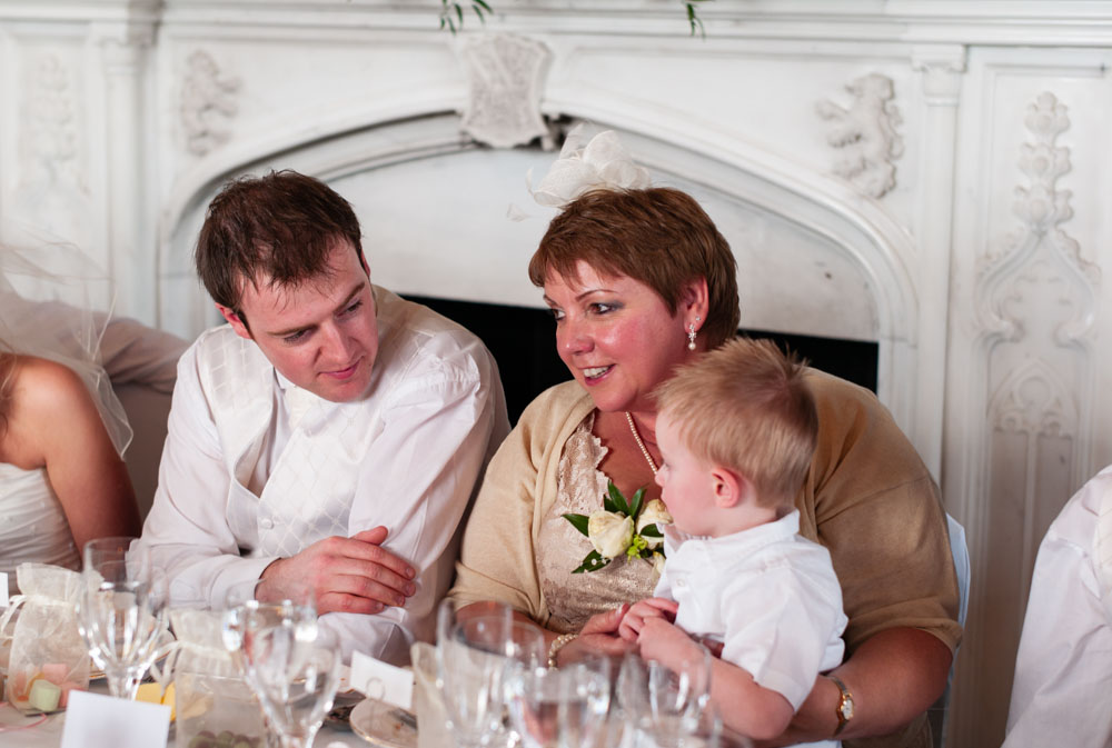 Groom’s mother holding her young grandson