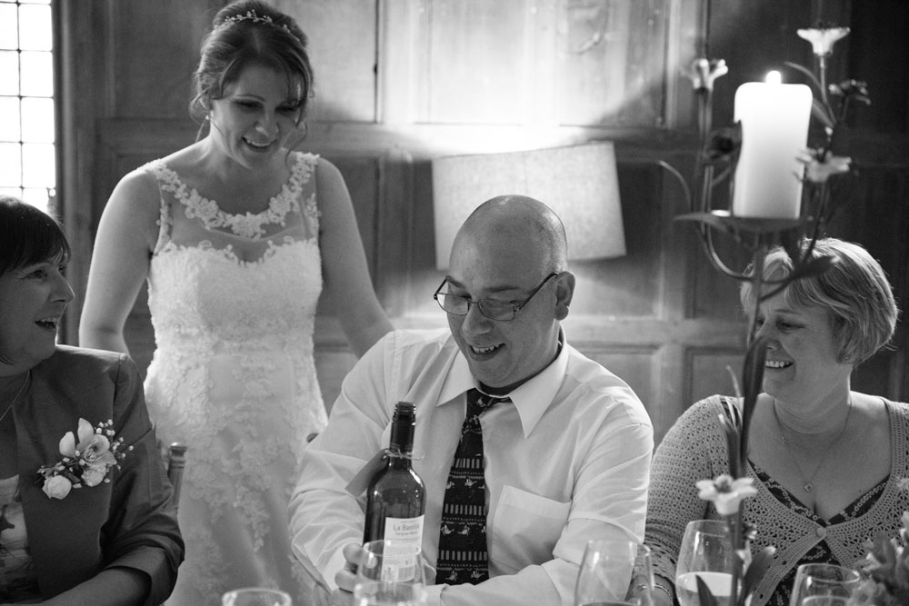 Bride walks around the table greeting friends and family.